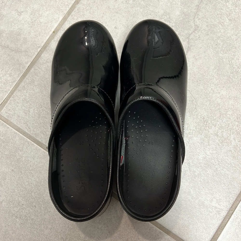 Sanita black patent clogs